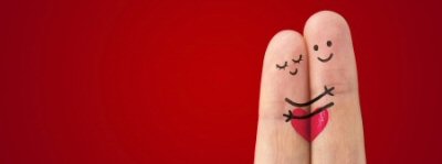 Two fingers next to each other have faces and hands drawn on them so it looks as if they are people hugging each other. A heart is drawn joining the two fingers.