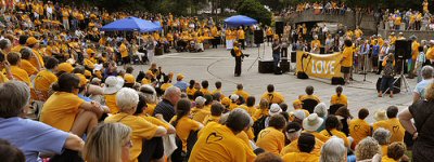 A large gathering of Unitarian Universalists wearing yellow 'Standing on the Side of Love' T-shirts at a demonstration.